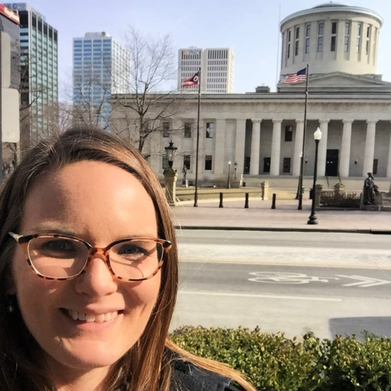 Living Music LLC Owner and Music Therapist Brittany Scheer posing in front of the Ohio State House for a music therapy advocacy day.
